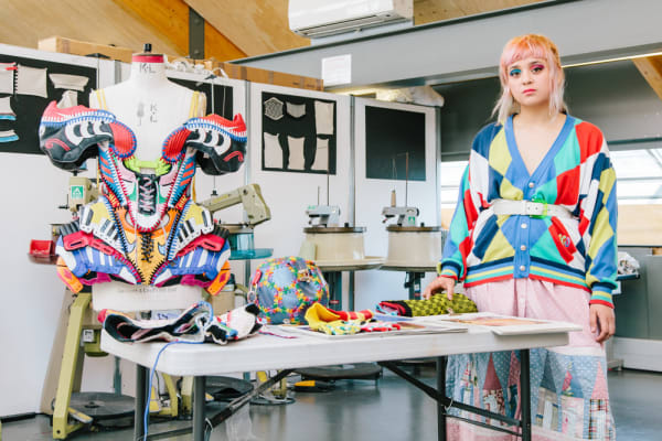 CSM graduate Paolina Russo pictured in a studio with her multicoloured design pieces