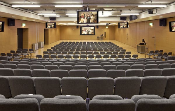 Rows of seats facing a screen in the LVMH Lecture Theatre at Central Saint Martins