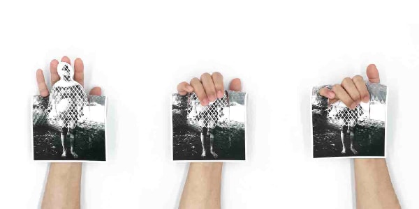 three hands hold postcards cut out
