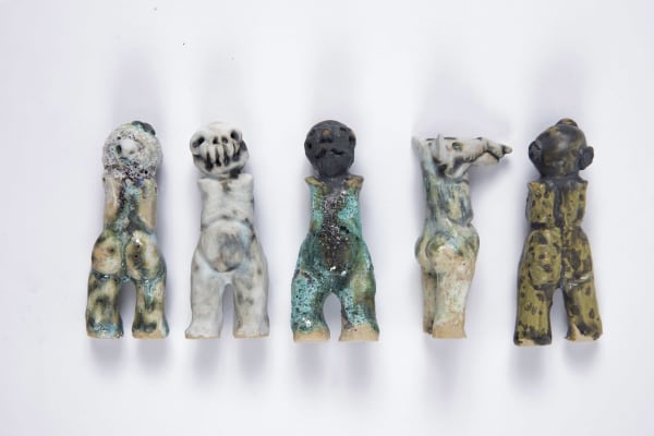 Five distorted human/animal ceramic figures