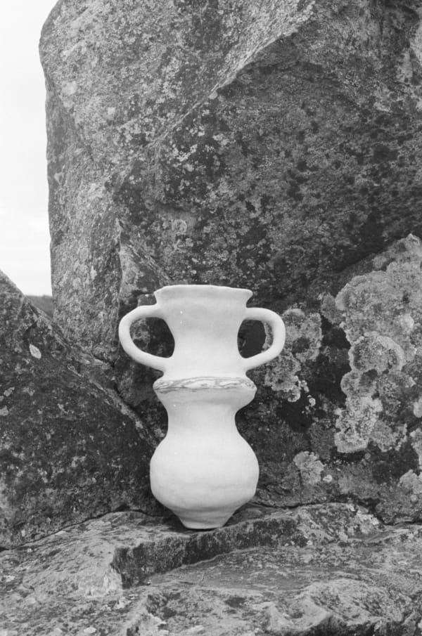A ceramic pot on a rock 