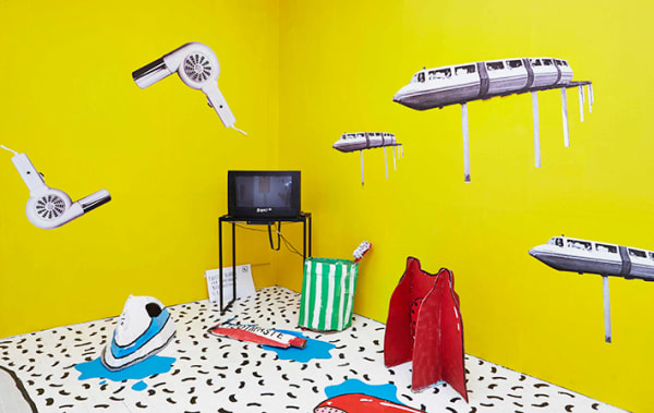 Yellow walls with the television on a table and objects in the air