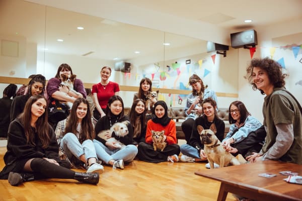 A group of UAL students meeting therapy puppies