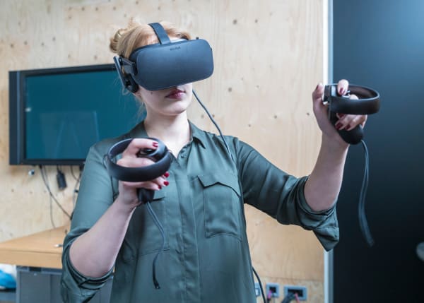 A person using a VR headset and controls