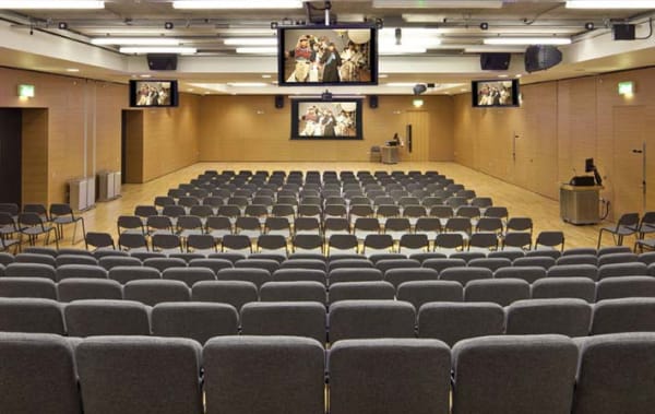 Photo of seats facing a stage in a lecture hall