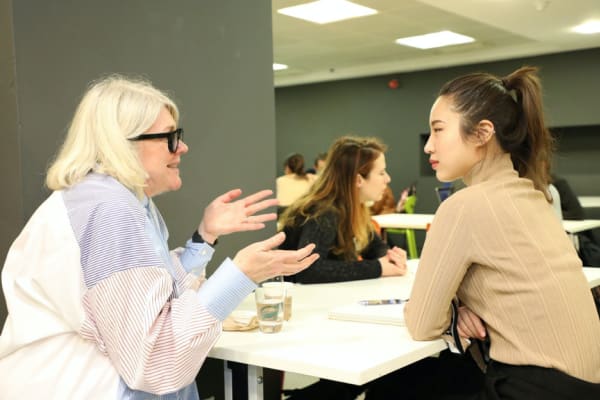 A mentor chatting to a mentee at an event.