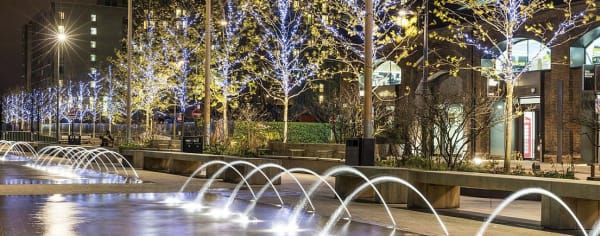 A row of fountains next to a row of benches