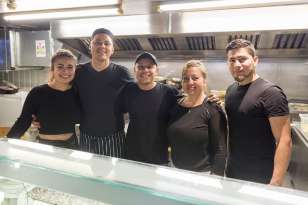 Staff at Costa Azul behind the counter at their restaurant.