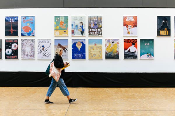 Girl walking past animation posters