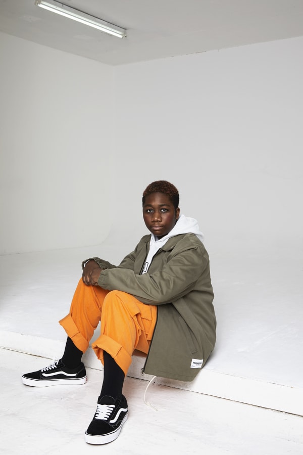 Man sitting on floor in streetwear