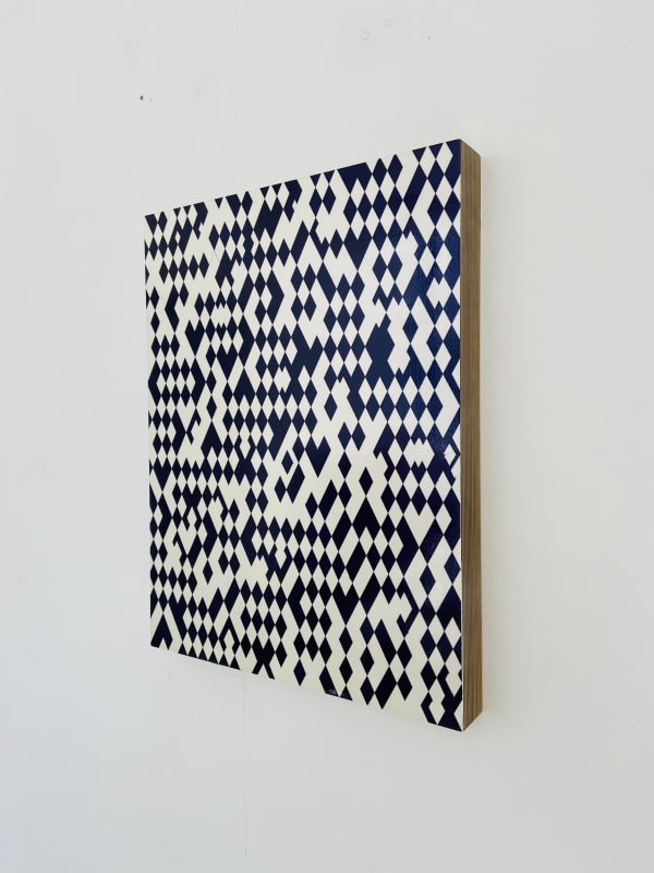 Geometric art in black and white hanging on a wall