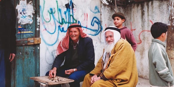 3-time refugees playing backgammon in the Palestinian Refugee Camp of Dheheishe, West Bank, 2002.
