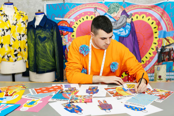 Tutor Dominic-Afsheen Akhavan-Moossavi working on his fashion illustrations.
