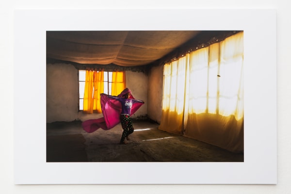 Image of girl running with a pink sheet