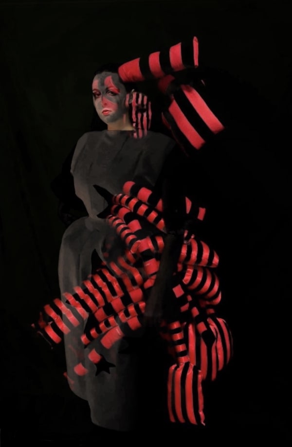 Figure wearing red and black striping outfit