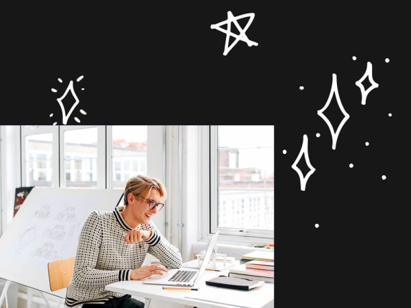 person sitting at a desk and working on a laptop