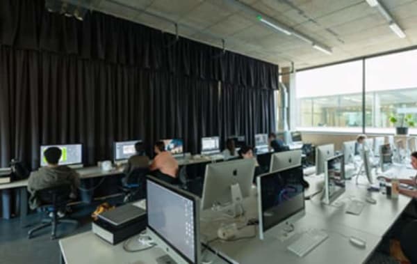 a room full of computers with students working 