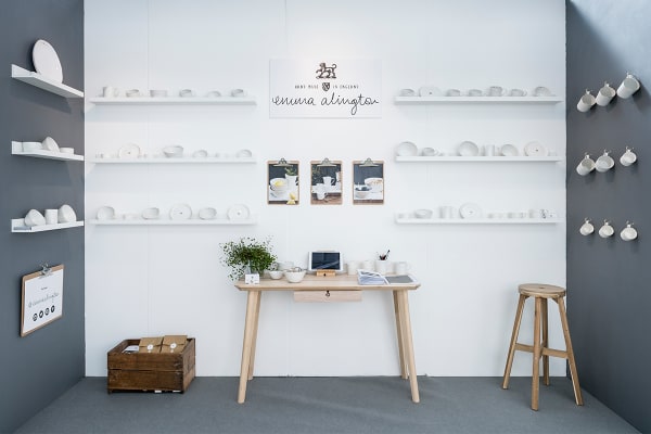 Exhibition space with white ceramic cups on display.