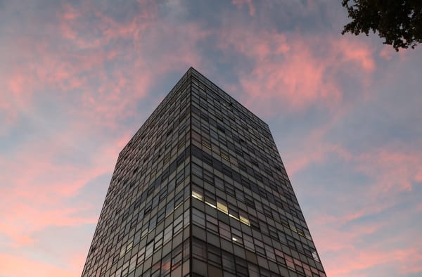Photograph of LCC's tower block against a pink sky.