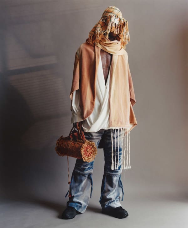 Man standing wearing blue and orange clothes