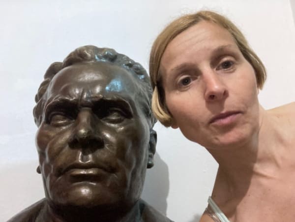 Nela Milic next to a sculpture of Tito