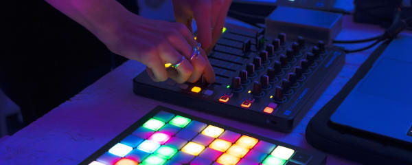 A hand operating a piece of music tech.