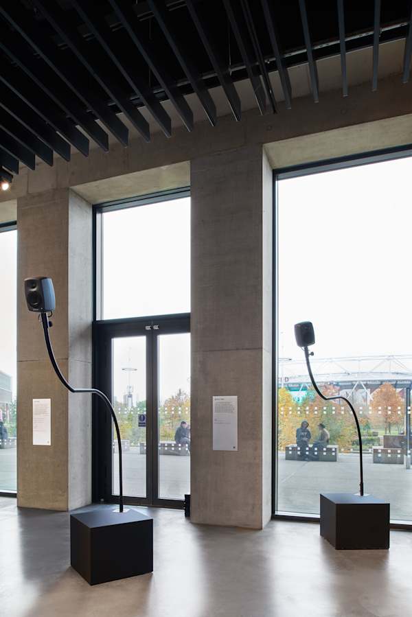 Gallery space with speakers on curved stands