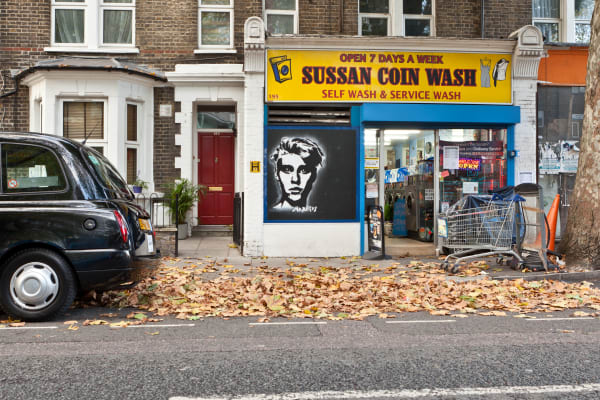 The front of a laundrette on an autumn street