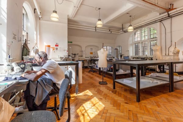 Student at sewing machine in sewing room at Lime Grove, London College of Fashion