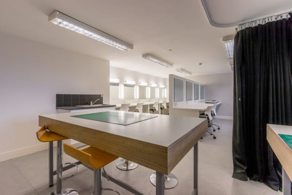 Workshop space, with make up station mirrors, large pattern cutting desks and space