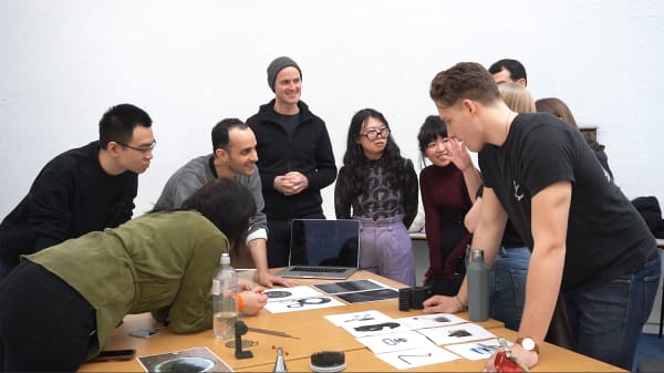 Class group around a table looking at material