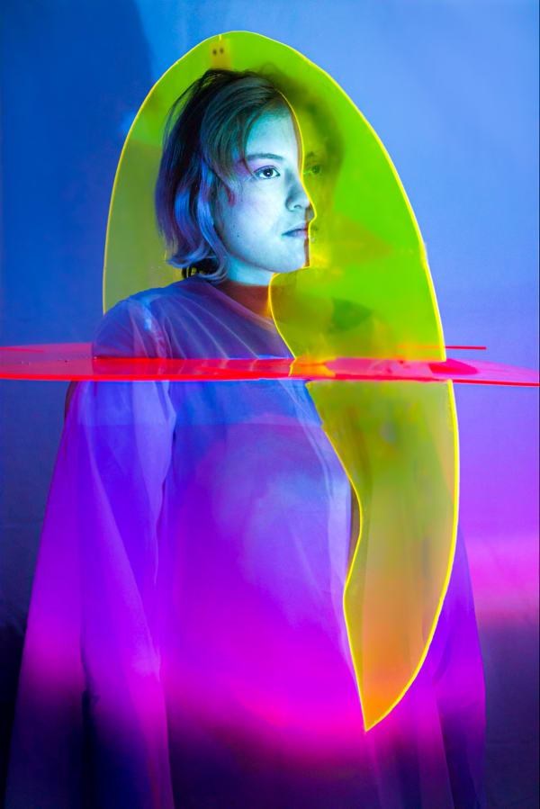 A model wearing a multi-coloured sculpture