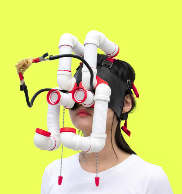 A person wearing a device over their face made up of connected tubes