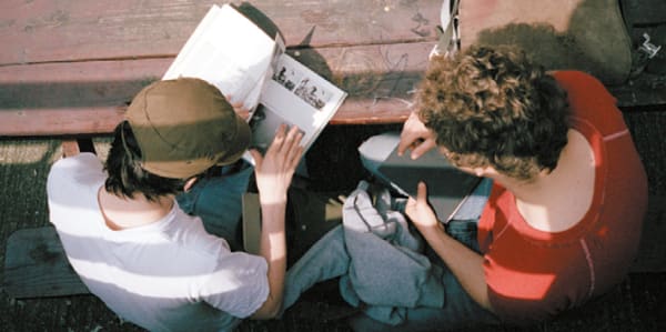 Two students reading reference books