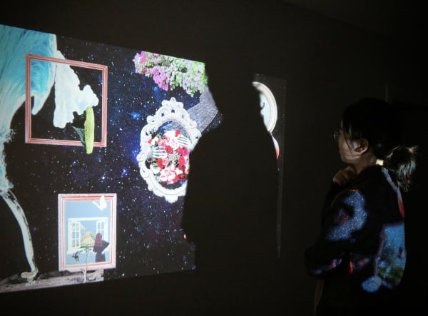 A person looking at a wall projection