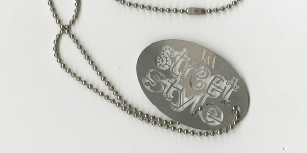 Close image of a necklace that reads 