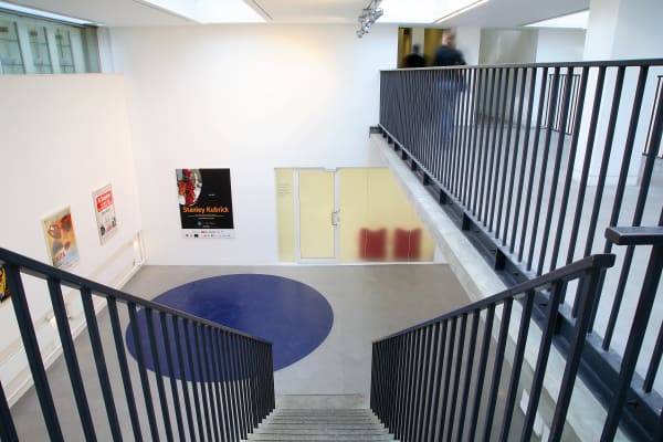 Flight of stairs leading to gallery space with door to archive