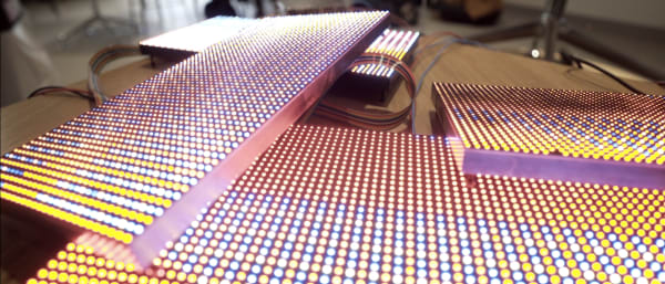 Colourful LED screens stacked on top of each other in a pile