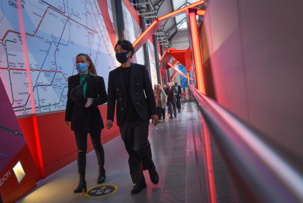 People walking down a corridor at London Transport Museum