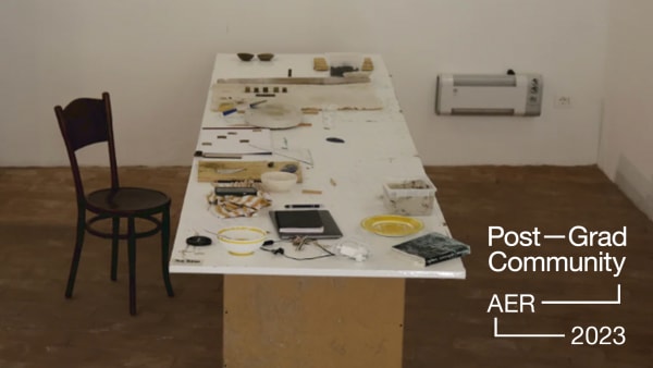 a photo of a table and a chair with art materials on top