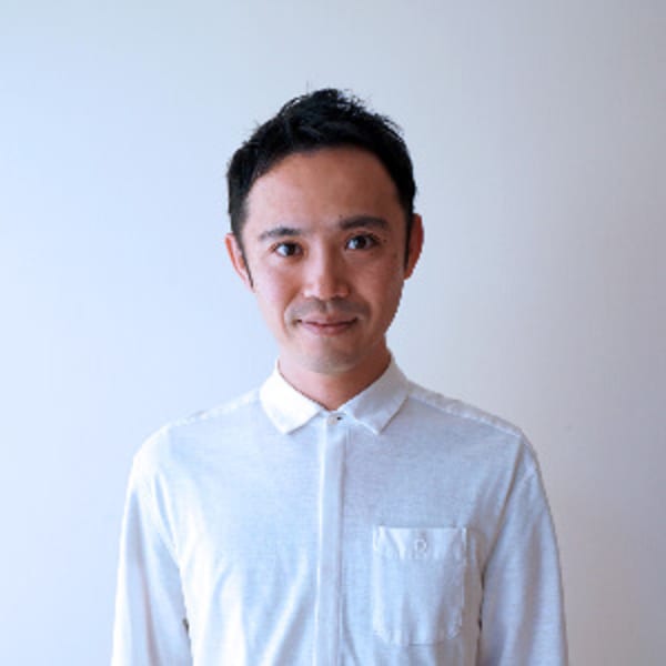Prof. Yasuaki Kakehi in a white shirt in front of a white wall