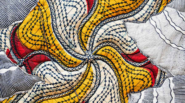 Close up of colourful fabric and stitching 