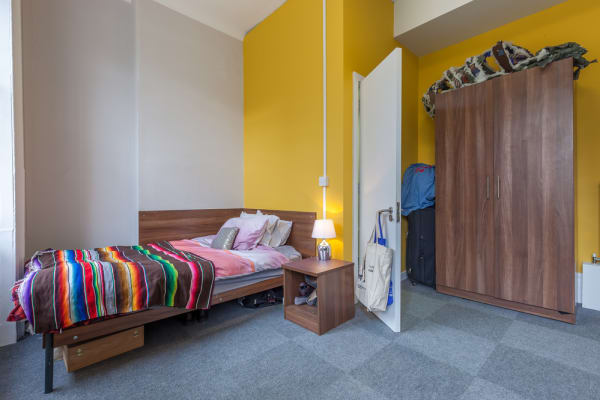 Large ensuite room with large wardrobe, single bed, chest of draws