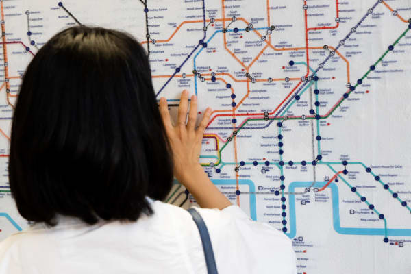 Woman reading London underground map