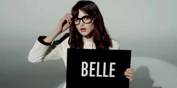 Corinne holding a sign that says 'Belle'
