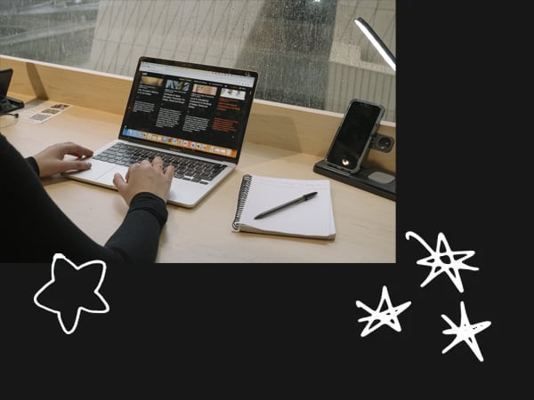 Student using a laptop in the library at East Bank. Photography by Ana Blumenkron.