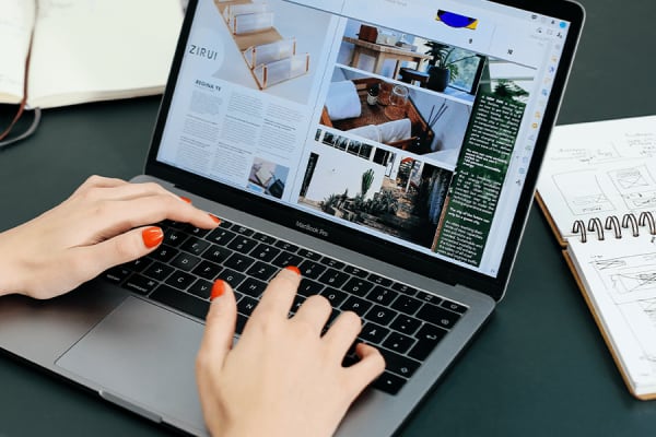 Close up photo of hands typing on a laptop