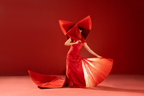 Asia lady in red costume dressed as a fox bride.