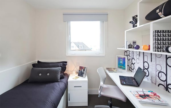 A small single room with white furnishing.