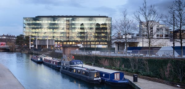 A large glass building opposite Regent's Canal